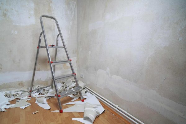 empty-room-with-bare-walls-ladder-and-old-wallpaper